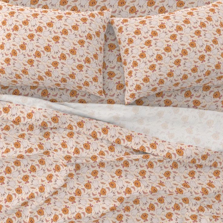 an orange flowered bed spread with white sheets and pillow cases on top of it