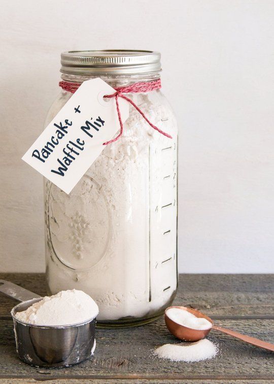 a mason jar filled with white powder next to a measuring spoon