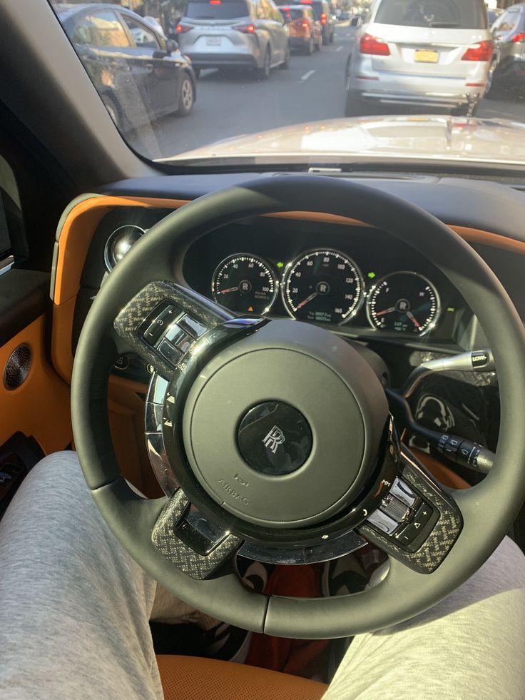 the interior of a car with dashboard, steering wheel and gauges on both sides