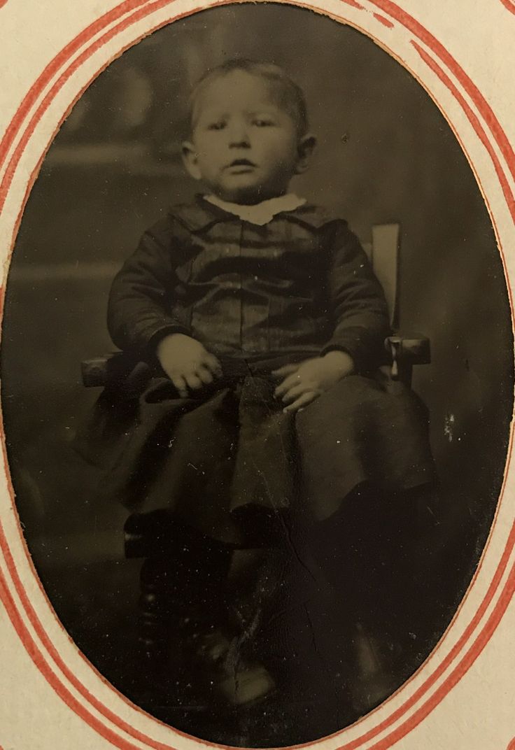 an old black and white photo of a baby