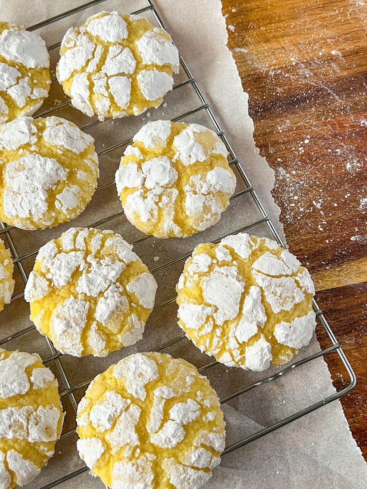 several powdered sugar cookies cooling on a wire rack