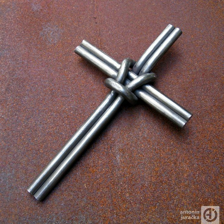 a metal cross sitting on top of a brown table