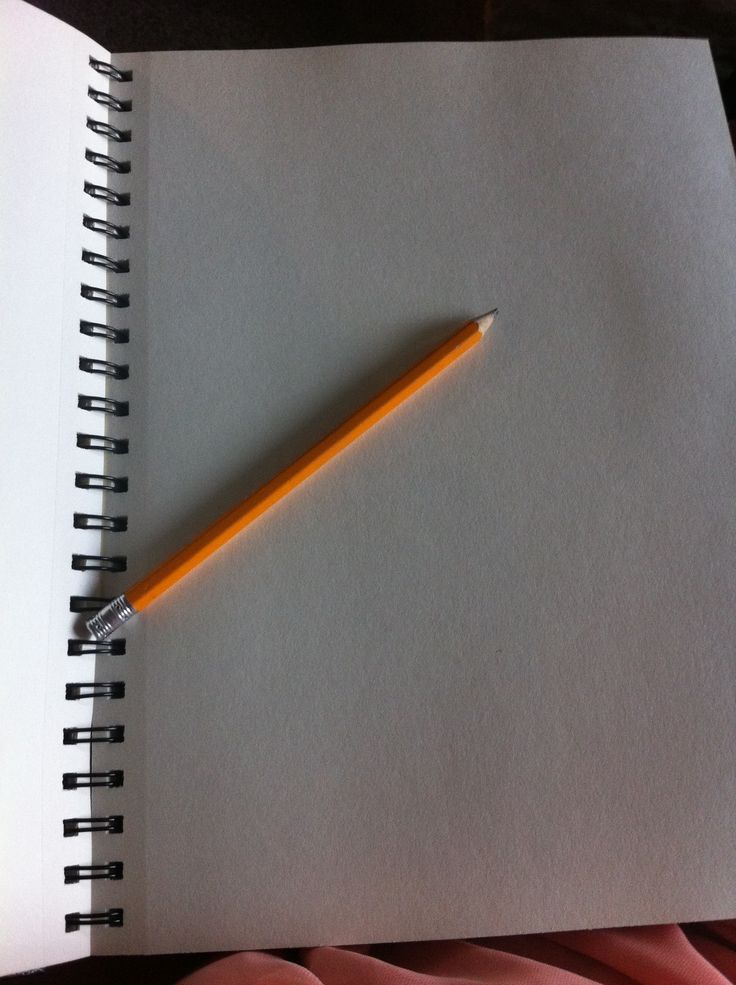 a yellow pencil resting on top of a white notebook