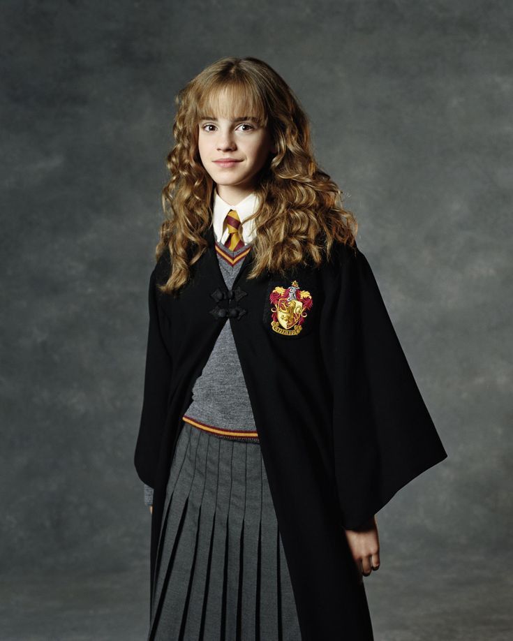 a woman in a harry potter costume posing for a photo with her hands on her hips