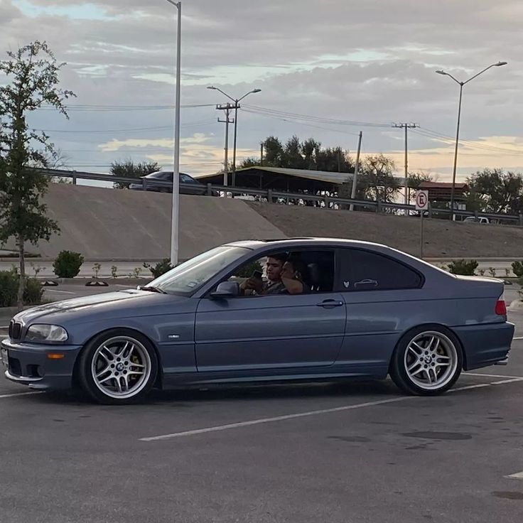 a blue car parked in a parking lot