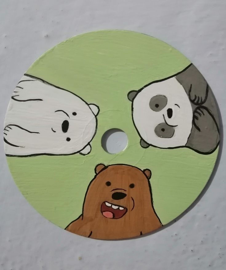 three bears and a bear face painted on a wooden disc