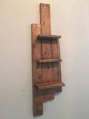 a wooden shelf mounted to the side of a wall