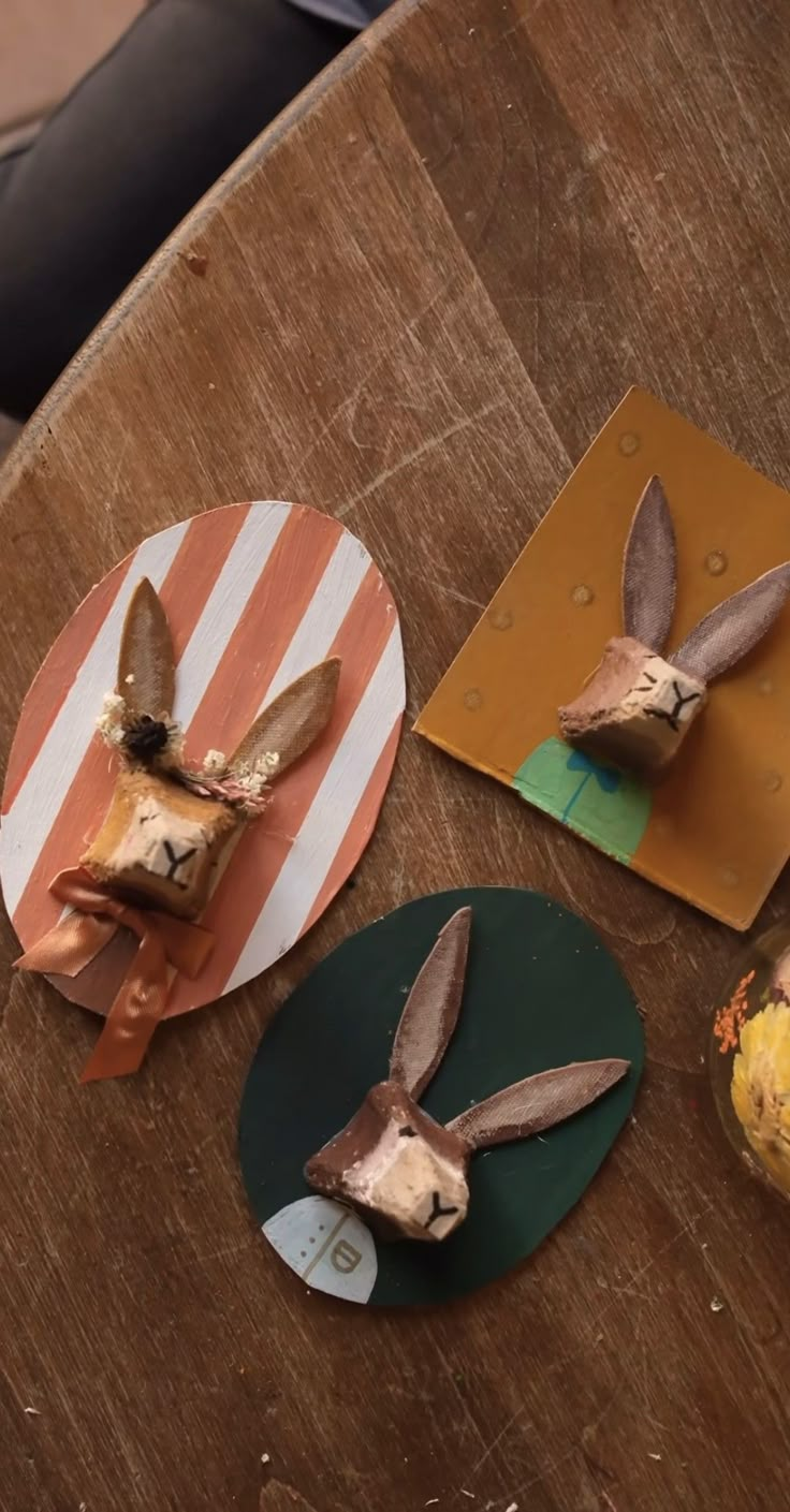 three paper plates with rabbits on them sitting on a table