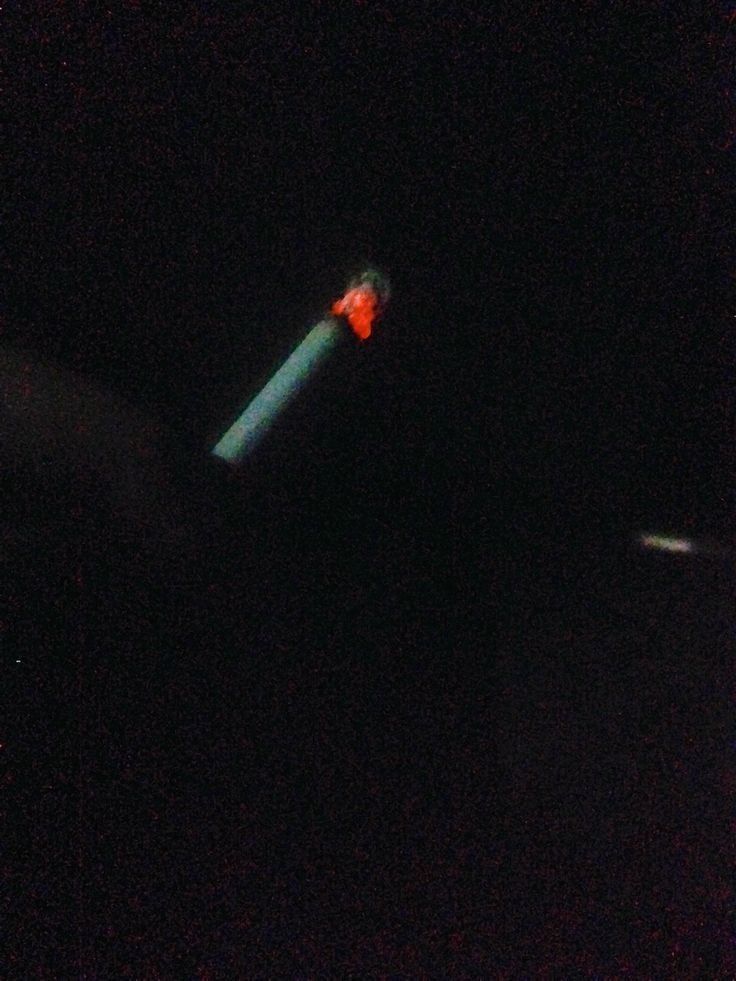 a blurry photo of a street light in the dark with red and green lights