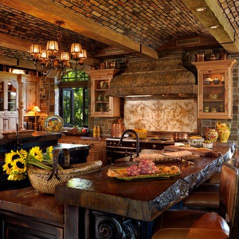 a large kitchen with an island in the middle and sunflowers on the counter