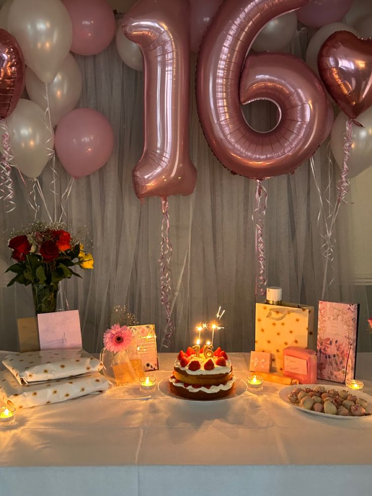 a table topped with lots of cake and balloons