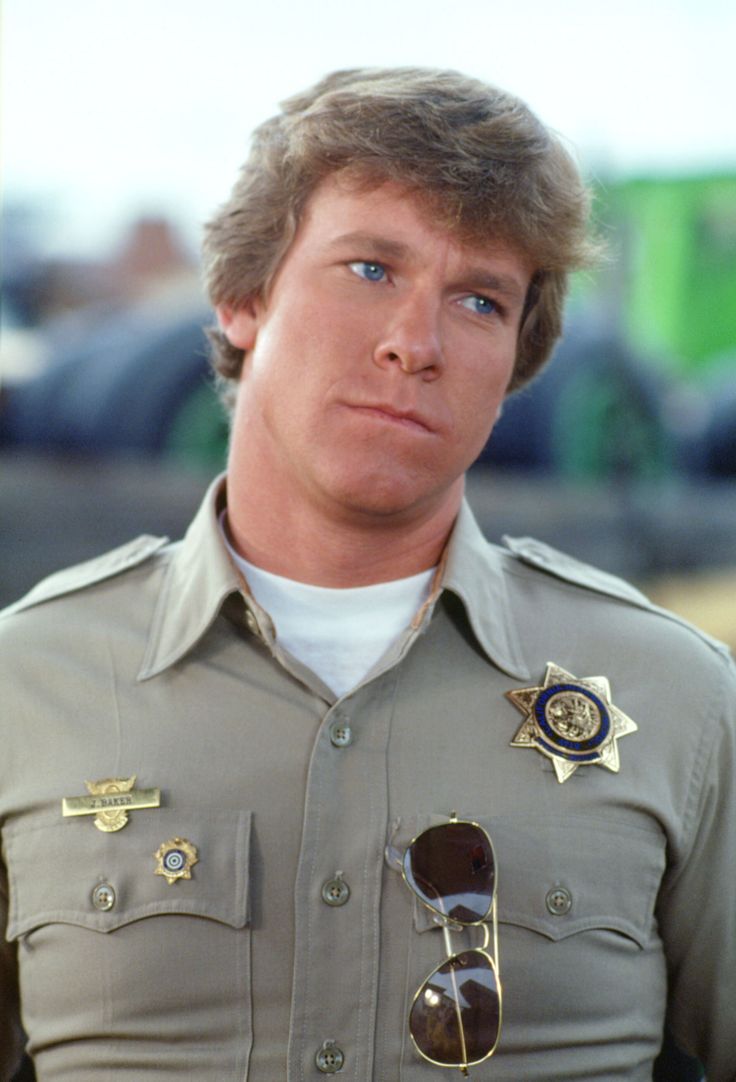 a close up of a person wearing a uniform with sunglasses on his head and looking off to the side