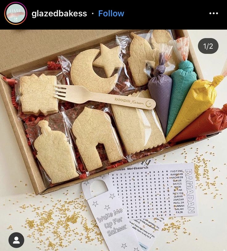 a box filled with cut out cookies in the shape of animals and letters on top of each other