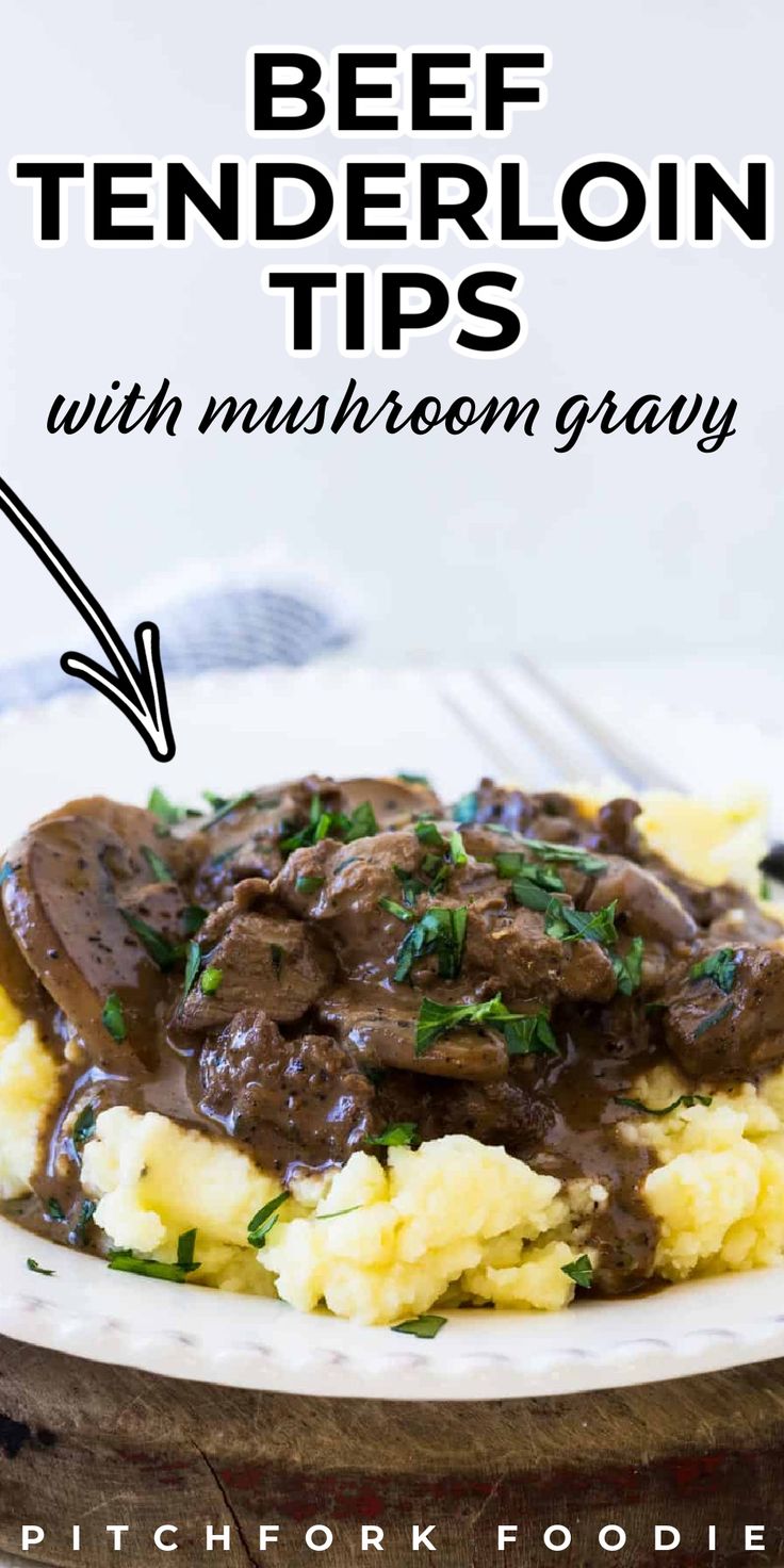 beef tenderion tips with mushroom gravy on a white plate over mashed potatoes