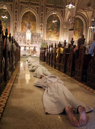 the people are laying on the floor in the church