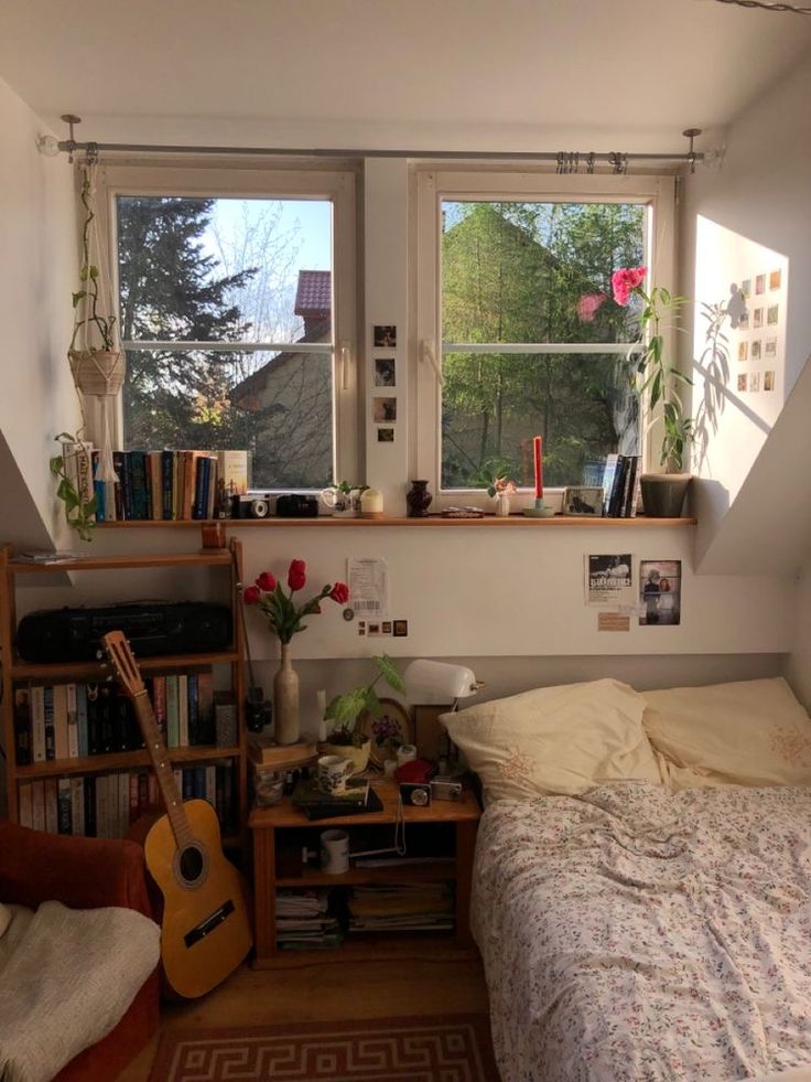 a bed room with a neatly made bed and a guitar