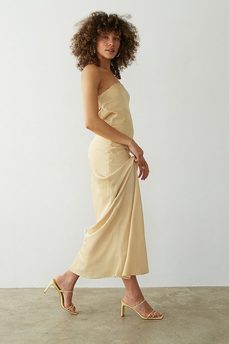 Stay RSVP ready in the Jayla Strapless Open Back Maxi Dress! This maxi dress features a strapless neckline, open back detail, and satin finish. Available in Honey; pair with some chic heels to polish off the fantasy!Details: Shell: 100% Polyester Lining: 95% Polyester, 5% Spandex Fully Lined Elastic Back Strap Silicone Grips Some Stretch Hand Wash in Cold Water/ Line Dry Chic One Shoulder Satin Summer Dress, Spring Satin Backless Dress For Date Night, One Shoulder Satin Dress For Date Night In Spring, One-shoulder Satin Dress For Date Night In Spring, Chic One-shoulder Satin Dress For Prom, Spring One-shoulder Satin Prom Dress, Chic One-shoulder Satin Prom Dress, One-shoulder Satin Prom Dress For Spring, One Shoulder Midi Dress For Summer Gala