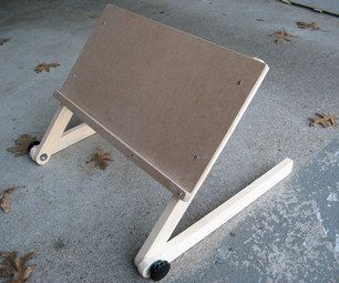 a small wooden table sitting on top of a cement floor next to a parking lot