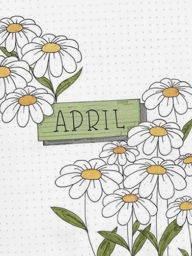 an open notebook with white flowers and the word april written on it's side