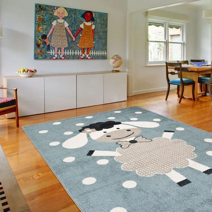 a blue rug with sheep on it in the middle of a room