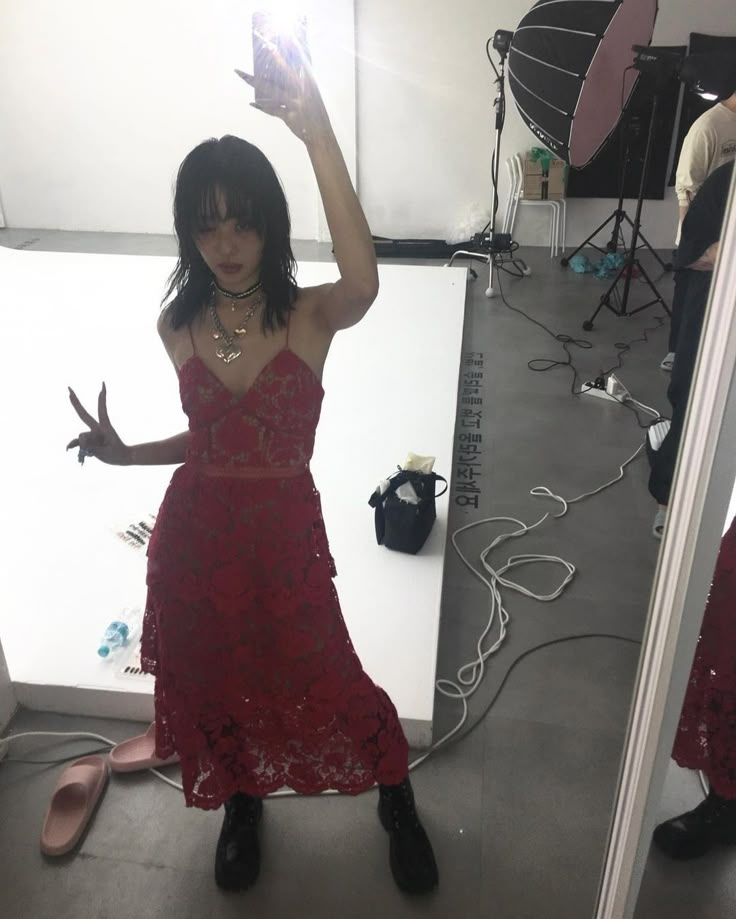 a woman in a red dress taking a selfie