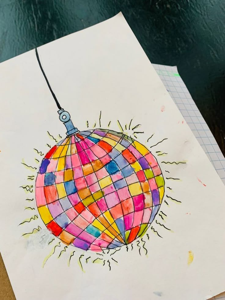 a drawing of a colorful hot air balloon on top of a white piece of paper