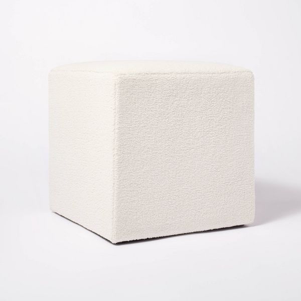 a white cube sitting on top of a white floor