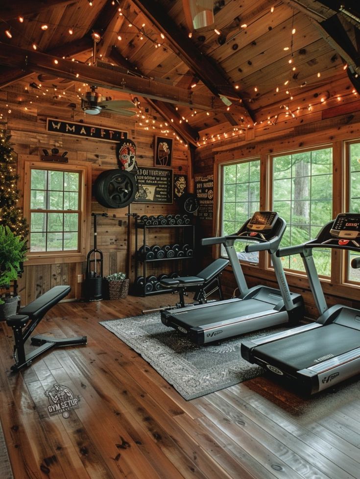 a home gym with treadmills, exercise bikes and christmas lights hanging from the ceiling