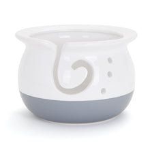 a white and grey ceramic bowl with the letter c in it's center, on a white background