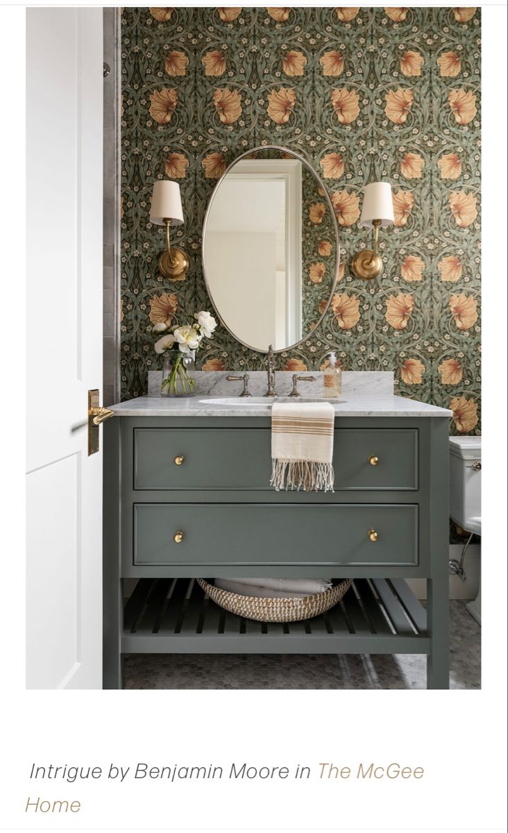 a bathroom with a sink, mirror and wallpaper on the walls is featured in this article