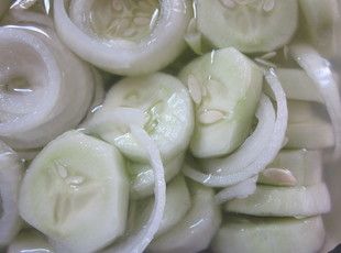 sliced onions are being cooked in a pan