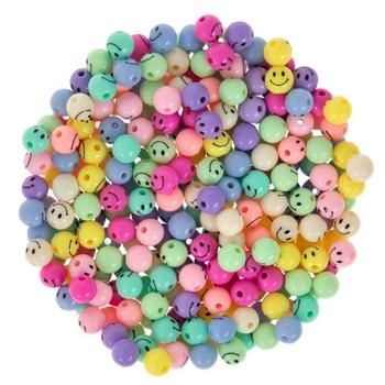 many different colored beads with smiley faces on them