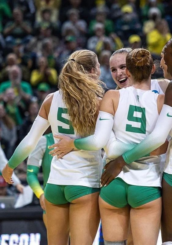 the women's volleyball team huddle together during a timeout