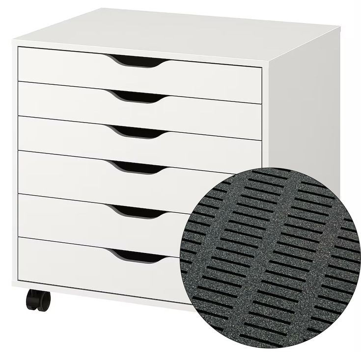 a white cabinet with five drawers and a black dot on the bottom half of it