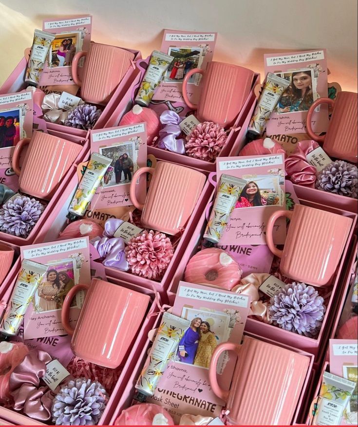 many pink mugs are stacked on top of each other with pictures and pine cones