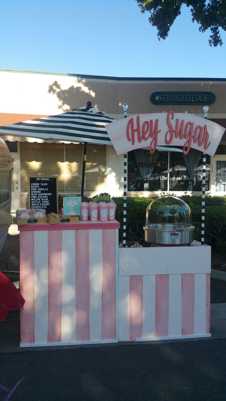 an ice cream stand with pink and white stripes