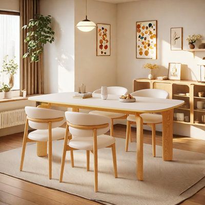 a dining room table with four chairs around it