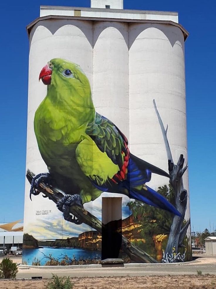 a large bird painted on the side of a water tower