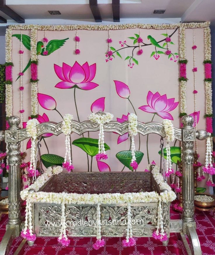 a bed with pink flowers on the wall and white trimmings, in front of a floral backdrop