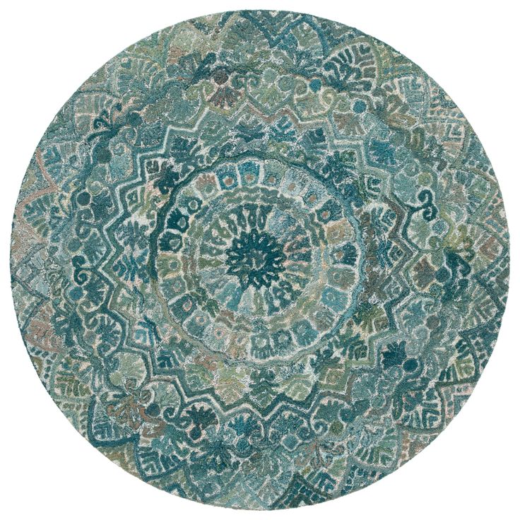 a round rug with an intricate design on the center and sides, in green tones