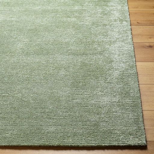 a light green rug on a wooden floor