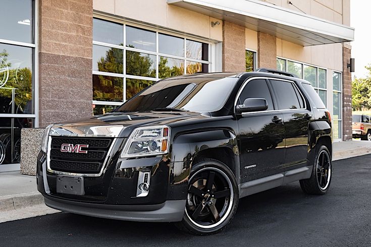 a black suv parked in front of a building