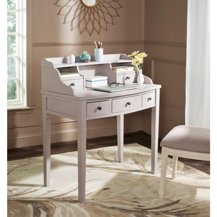 a white desk with two drawers and a chair in front of the table is next to a window