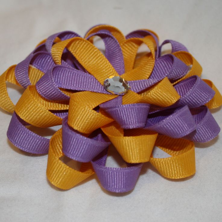 an orange and purple bow on a white background