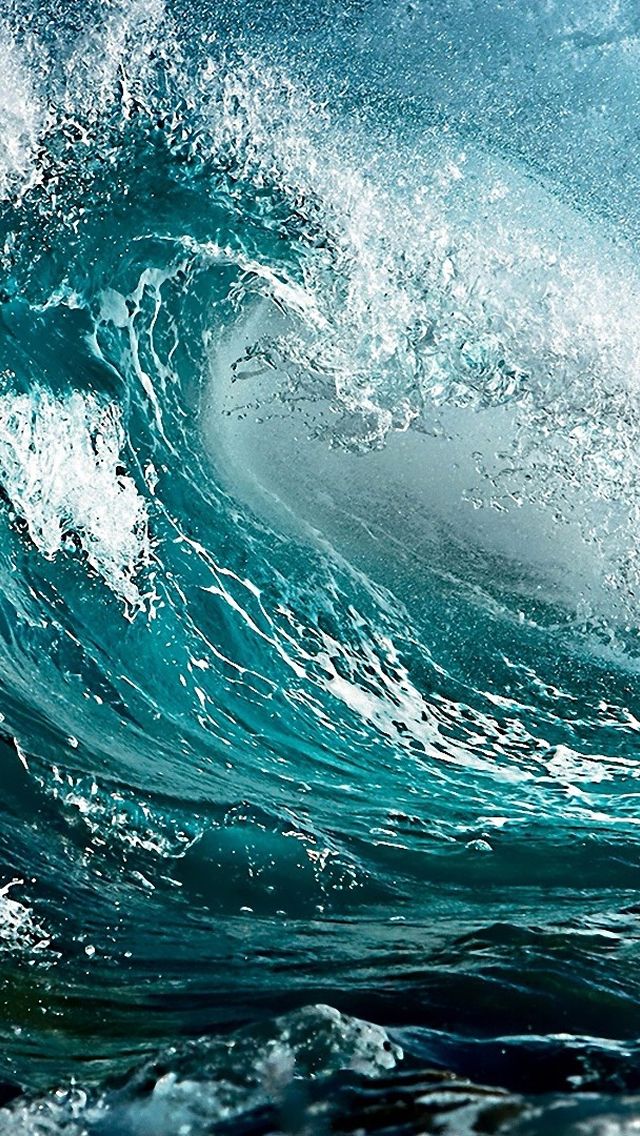 an ocean wave is breaking over the top of it's head in blue water