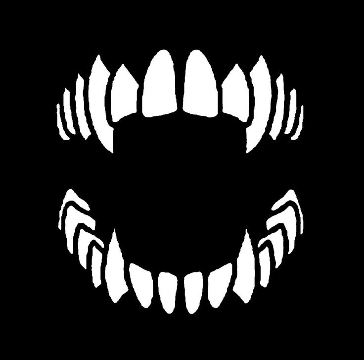 a black and white image of an evil face with fangs on it's teeth