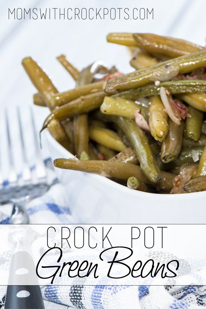 a white bowl filled with green beans on top of a blue and white table cloth