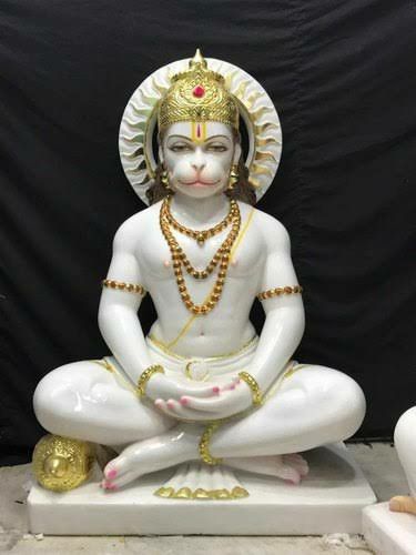 a white statue sitting in the middle of a room