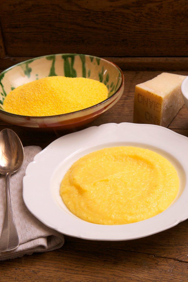 a table topped with white plates and bowls filled with yellow cake batter next to butter