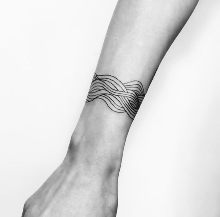 a black and white photo of a person's foot with a tattoo on it